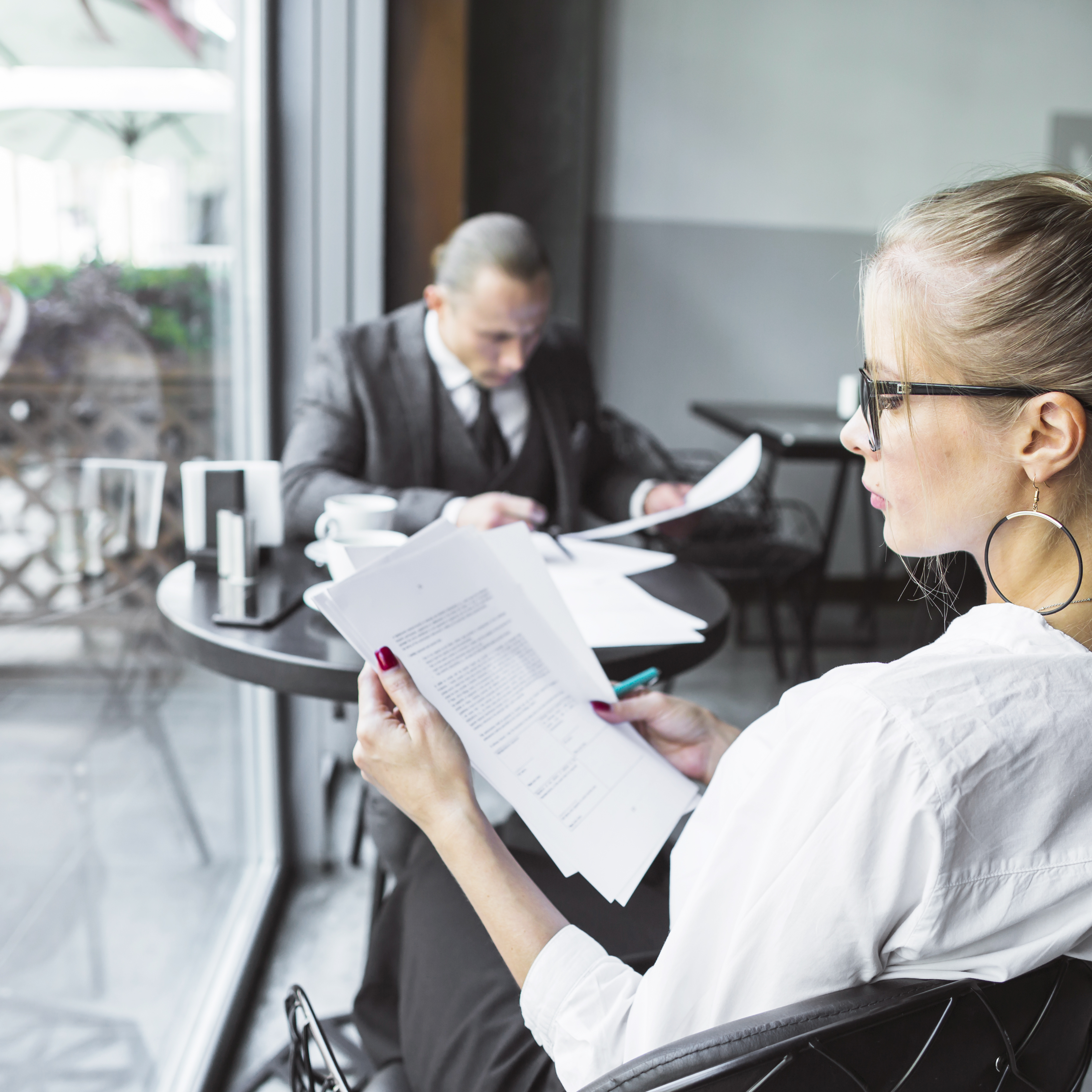 businesswoman checking documents restaurant